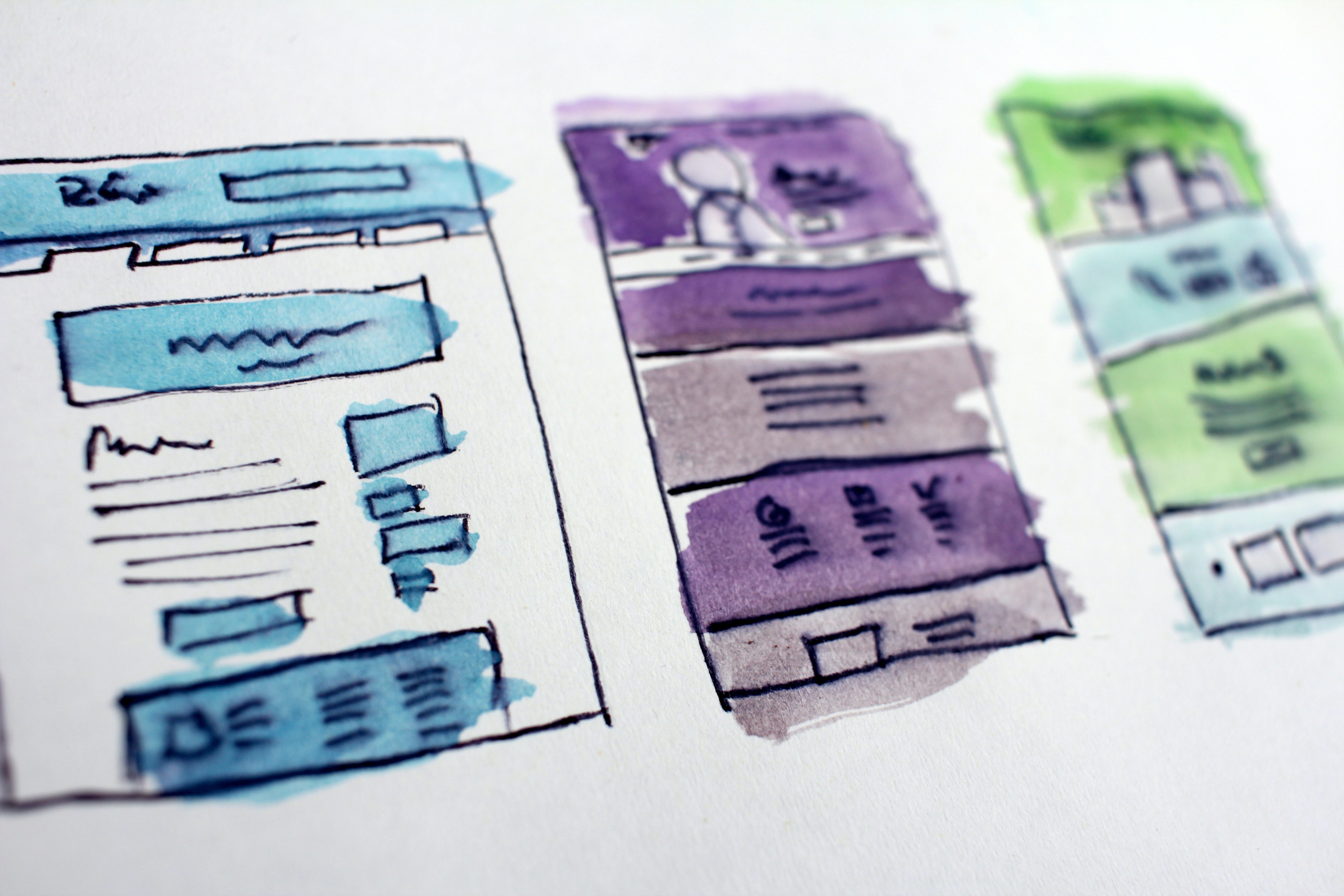 Low-fidelity wireframes drawn on paper.